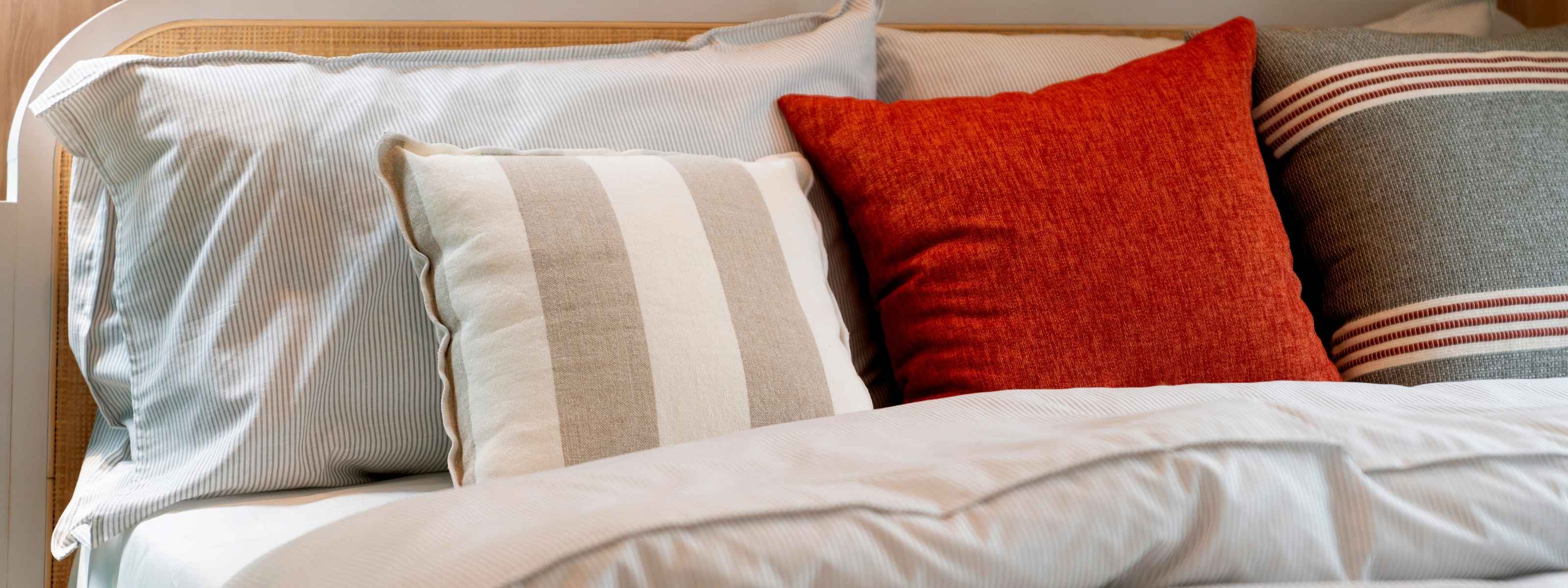 Elegant bedding setup featuring striped pillows and premium bedroom styling by AnAká Homes